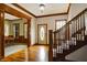 Elegant entryway with hardwood floors, wooden staircase, and views into dining room at 7178 Lockford N, Avon, IN 46123