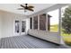Relaxing screened porch with gray deck and ceiling fan, offering a view of the backyard at 7178 Lockford N, Avon, IN 46123