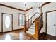 Bright entryway with hardwood floors, a white door, and a wooden staircase at 7178 Lockford N, Avon, IN 46123