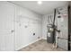 Bright laundry room with washer, dryer hookups, and shelving at 4633 Angelica Dr, Indianapolis, IN 46237
