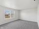 Bright bedroom with grey carpet and a large window at 4633 Angelica Dr, Indianapolis, IN 46237