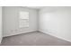 Spacious bedroom with grey carpet and a window at 4633 Angelica Dr, Indianapolis, IN 46237