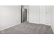Well-lit bedroom with grey carpet and door to hallway at 4633 Angelica Dr, Indianapolis, IN 46237