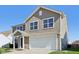 Two-story house with beige siding, white garage door, and landscaping at 4633 Angelica Dr, Indianapolis, IN 46237