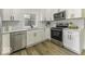 Modern kitchen with white shaker cabinets, stainless steel appliances, and white subway tile at 452 W Broadway St, Greenwood, IN 46142