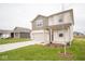 Two-story house with beige and brown siding, a white door, and a two-car garage at 9145 Kavanaugh Dr, Indianapolis, IN 46239