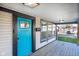 Bright teal front door adds a pop of color to the home's exterior at 2221 E Michigan St, Indianapolis, IN 46201