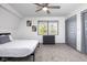 Bedroom with a ceiling fan, gray carpet, and sliding door at 2221 E Michigan St, Indianapolis, IN 46201