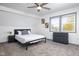 Cozy bedroom with a ceiling fan, gray carpet, and dresser at 2221 E Michigan St, Indianapolis, IN 46201