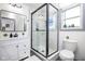 Clean bathroom with white vanity, black matte fixtures, and walk in shower at 2221 E Michigan St, Indianapolis, IN 46201