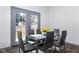 Dining area with glass table, gray chairs, and access to backyard at 2221 E Michigan St, Indianapolis, IN 46201