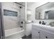Modern bathroom with marble tile, soaking tub, and updated vanity at 2221 E Michigan St, Indianapolis, IN 46201
