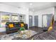 Bright living room with gray sofas, coffee table, and backyard view at 2221 E Michigan St, Indianapolis, IN 46201