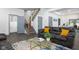 Open concept living room with gray sofas and a view into the kitchen at 2221 E Michigan St, Indianapolis, IN 46201