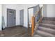 Modern entryway with gray door, half bathroom, and stairs to the second floor at 2221 E Michigan St, Indianapolis, IN 46201