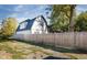Side view of the house, showing the backyard and fence at 2221 E Michigan St, Indianapolis, IN 46201