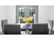 Dining area with glass table, gray chairs and door leading to backyard at 2221 E Michigan St, Indianapolis, IN 46201
