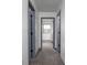 Clean hallway with gray carpet and doors to bedrooms and other rooms at 2221 E Michigan St, Indianapolis, IN 46201
