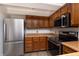 Galley kitchen with stainless steel appliances and wood cabinets at 8168 Shorewalk Dr # A, Indianapolis, IN 46236