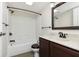 Modern bathroom with tub/shower combo and dark wood vanity at 8168 Shorewalk Dr # A, Indianapolis, IN 46236