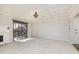 Spacious living room with fireplace, sliding glass doors to balcony, and neutral carpeting at 8168 Shorewalk Dr # A, Indianapolis, IN 46236