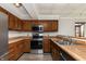 Galley kitchen with stainless steel appliances and wood cabinets at 8168 Shorewalk Dr # A, Indianapolis, IN 46236