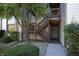 Condo building entry with wooden stairs and landscaping at 8168 Shorewalk Dr # A, Indianapolis, IN 46236