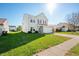 Two-story house with beige siding, a white garage door, and a well-maintained lawn at 3159 Hurst St, Whiteland, IN 46184