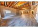 Unfinished basement with exposed beams and wood flooring at 808 Copperfield Xing, Danville, IN 46122