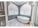 Bathroom with free standing tub and arched windows at 808 Copperfield Xing, Danville, IN 46122