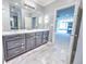 Bathroom with dark vanity, large mirror and view to sunroom at 808 Copperfield Xing, Danville, IN 46122