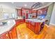 Modern kitchen with a large island, stainless steel appliances, and hardwood floors at 808 Copperfield Xing, Danville, IN 46122