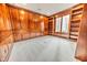 Library with wood paneled walls, built-in bookshelves, and carpet flooring at 808 Copperfield Xing, Danville, IN 46122
