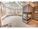 Sunroom with a fireplace and a view of the backyard at 808 Copperfield Xing, Danville, IN 46122