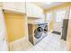 Laundry room with washer, dryer, cabinets, and exterior access at 808 Copperfield Xing, Danville, IN 46122