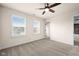 Bright bedroom with two windows, carpet, and a ceiling fan at 16703 Ayshire Dr, Fishers, IN 46037