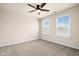 Cozy bedroom with two windows, carpet, and a ceiling fan at 16703 Ayshire Dr, Fishers, IN 46037