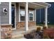 Covered porch with white columns, stone accents, and a glass door at 16703 Ayshire Dr, Fishers, IN 46037