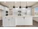 White kitchen with large island and stainless steel appliances at 16703 Ayshire Dr, Fishers, IN 46037