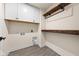 Basement laundry room with upper cabinets and wood shelves at 16703 Ayshire Dr, Fishers, IN 46037
