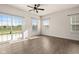 Living room with hardwood floors, large windows, and sliding glass doors at 16703 Ayshire Dr, Fishers, IN 46037