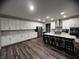 Open concept kitchen with white cabinets and a large island at 3609 Merchmont Rd, Bargersville, IN 46106
