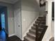 Modern staircase with dark wood railings and grey carpet at 3609 Merchmont Rd, Bargersville, IN 46106