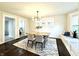 Bright dining room with wood floors and modern chandelier at 2641 Guilford Ave, Indianapolis, IN 46205