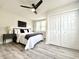 Main bedroom with a ceiling fan, comfortable bed, and ample closet space at 2641 Guilford Ave, Indianapolis, IN 46205