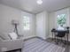 Cozy bedroom with a comfortable armchair, a work desk, and plenty of natural light at 2641 Guilford Ave, Indianapolis, IN 46205