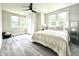 Bright bedroom with a ceiling fan, comfortable bed, and ample closet space at 2641 Guilford Ave, Indianapolis, IN 46205