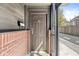 Private entrance with a brown door and brick accents at 1521 N Alabama St # L, Indianapolis, IN 46202