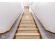 Clean, light-colored wooden staircase with dark wood railings at 1521 N Alabama St # L, Indianapolis, IN 46202