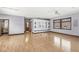 Hardwood floor living room with open concept kitchen and built-in shelving at 1521 N Alabama St # L, Indianapolis, IN 46202